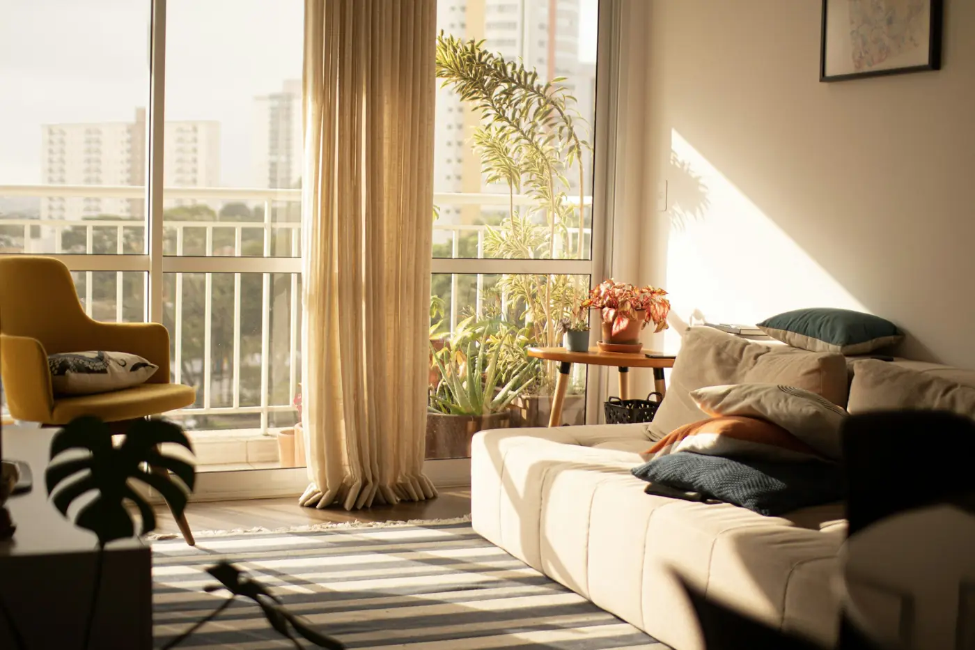 Sunlit living room with a large window and a clean, calm space